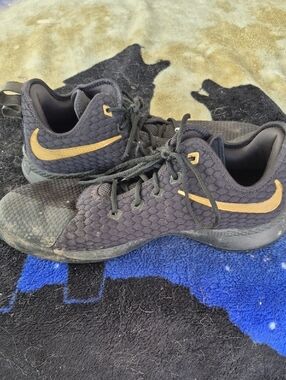 Nike Black Sneakers with Gold Swoosh Accent